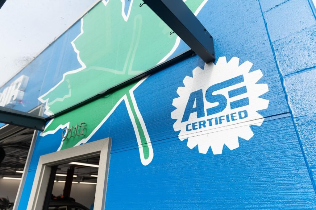 ASE Certified emblem painted on the Chuck's Auto Repair North Seattle building