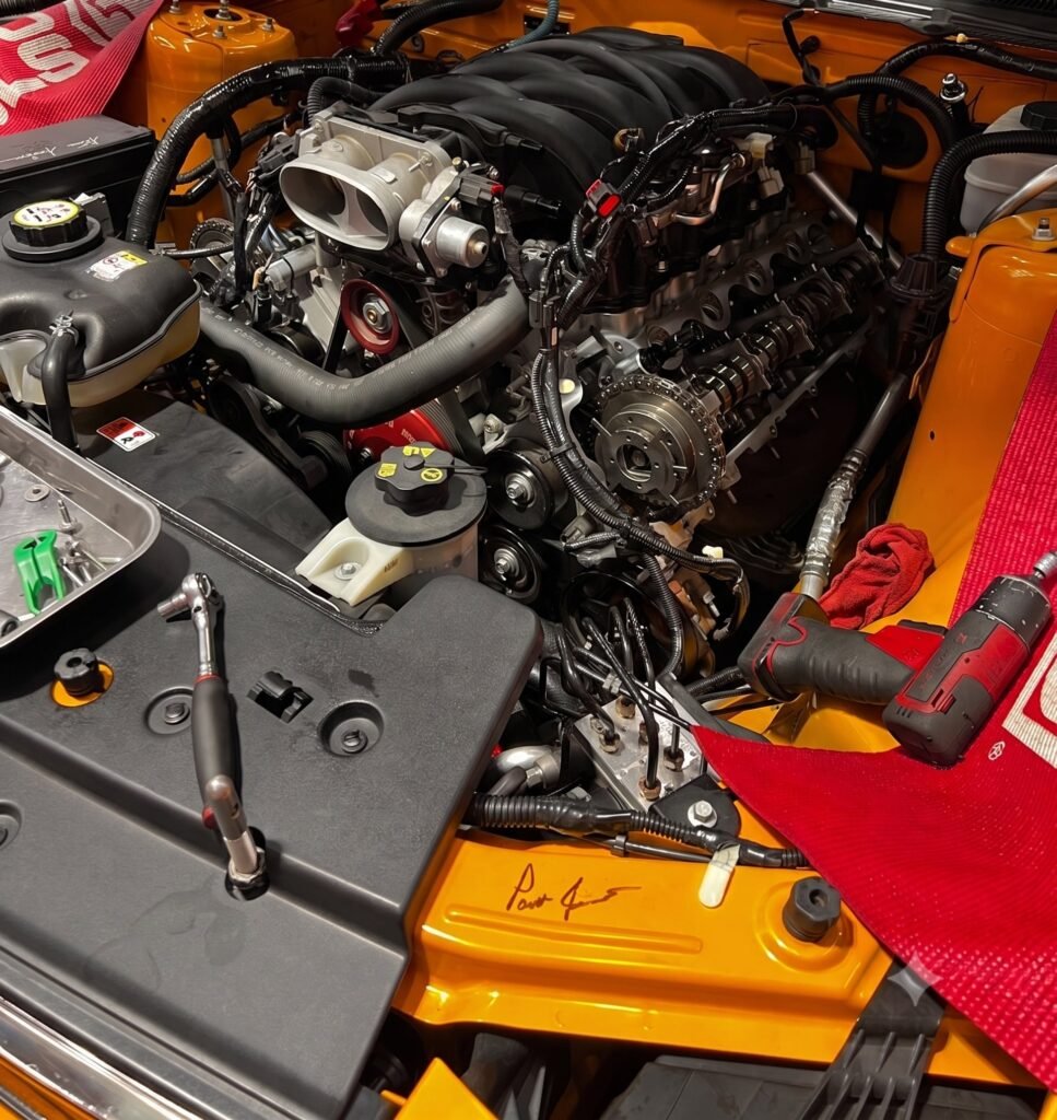 Ford Mustang V8 engine with valve cover removed for teardown inspection at Chuck's Auto Repair in North Seattle