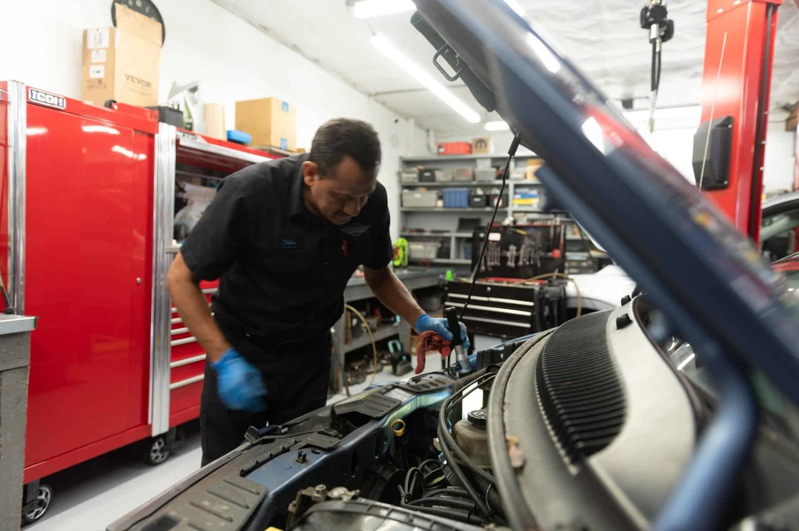 A technician testing the battery and charging system at Chuck's Auto Repair North Seattle