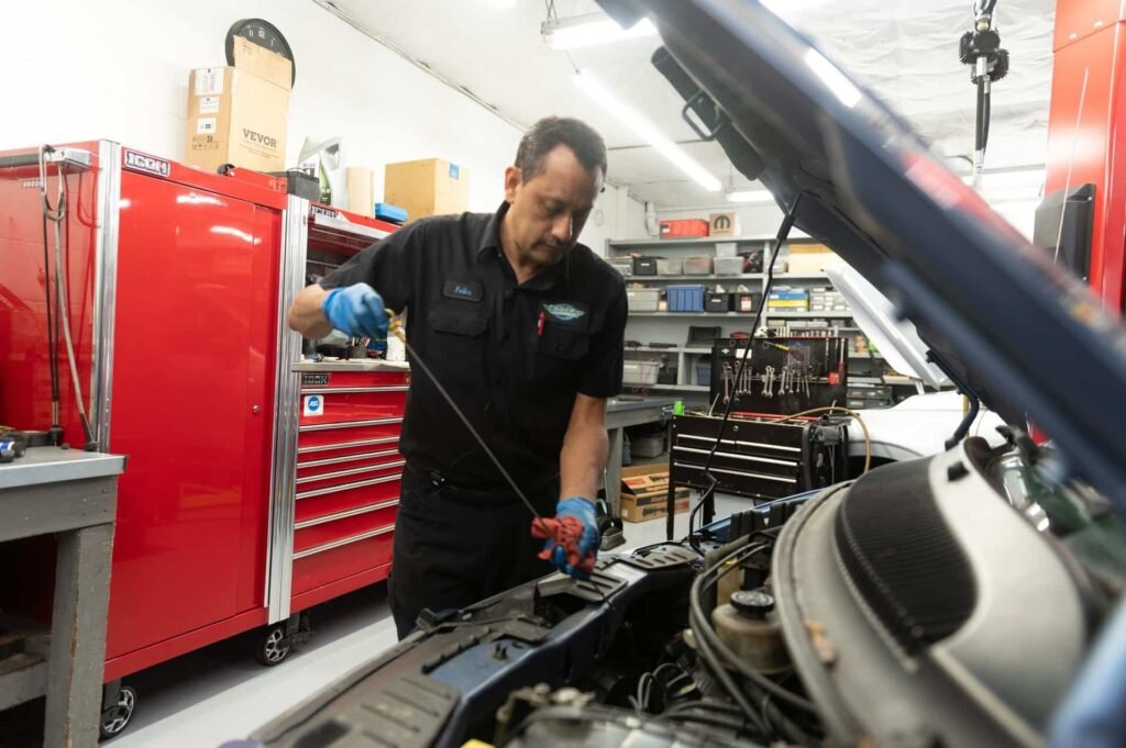 A technician verifying oil level during an oil change at Chuck's Auto Repair North Seattle