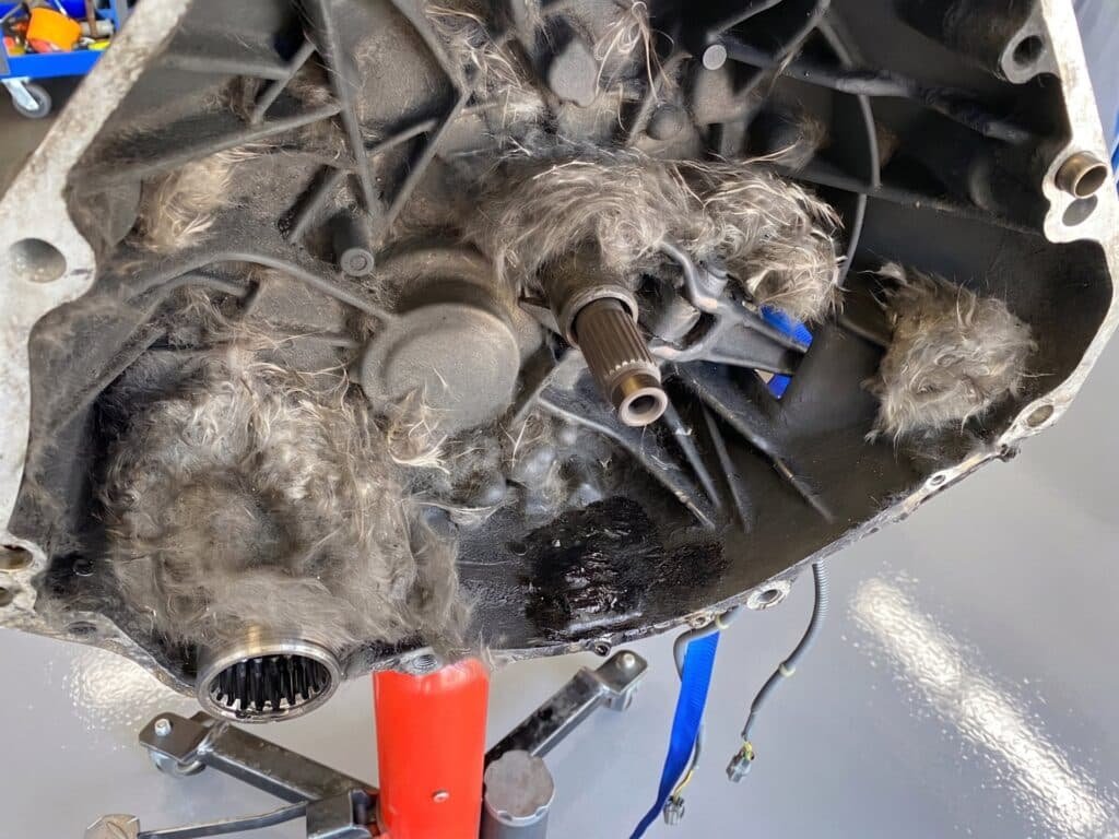 Shredded clutch friction material inside a transmission bellhousing after clutch failure, at Chuck's Auto Repair in North Seattle