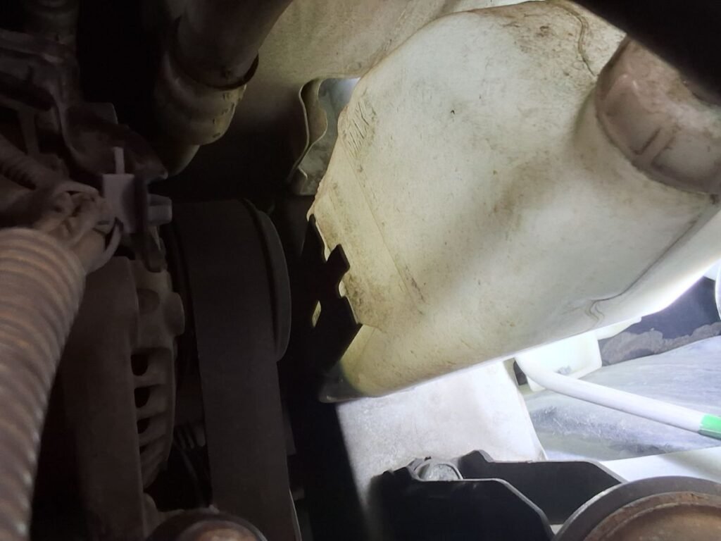 Engine coolant being inspected or serviced on a Honda.