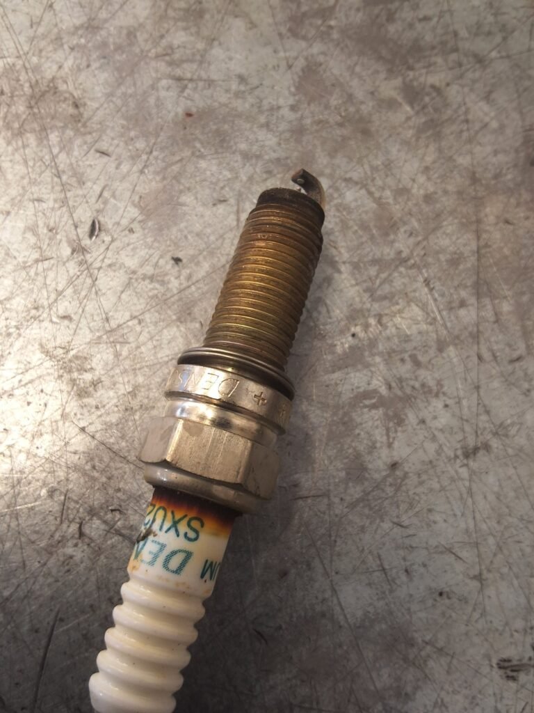 Used spark plug removed from a Honda CR-V for inspection.