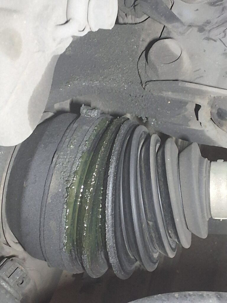 Torn front CV axle boot found during inspection of a 2015 Lexus RX450h.